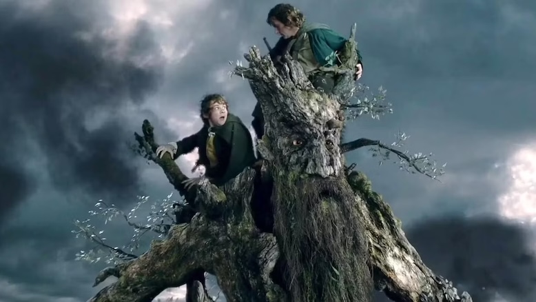 The two hobbits Merry and Pippin riding on the shoulders of Treebeard